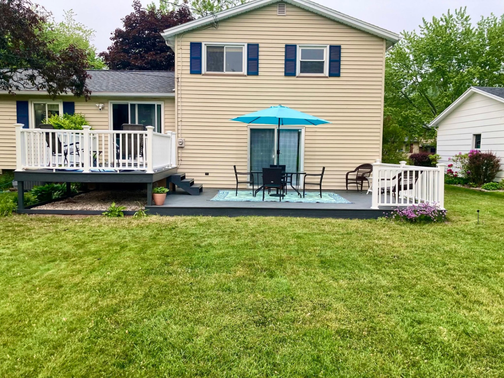 Low-profile gray composite deck with white railing and black aluminum balusters